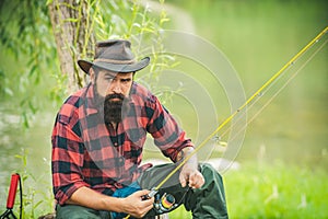 Trout on a hook. Man fly fishing. Brown trout being caught in fishing net. Fly fisherman using fly fishing rod in