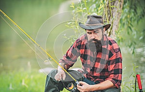 Trout on a hook. Man fly fishing. Brown trout being caught in fishing net. Fly fisherman using fly fishing rod in