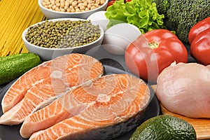 Trout steak, chicken, chickpeas, mung beans and vegetables closeup. A set of products for a flexible diet