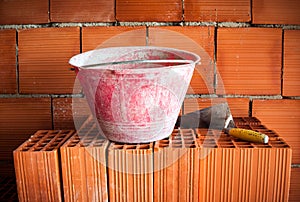 Trowel, bucket and bricks