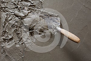 Trowel with wet concrete floor photo