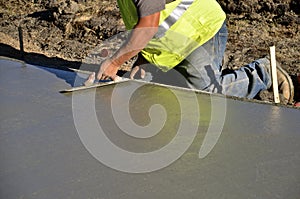 Troweling wet concrete