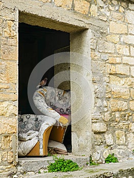 Trraditional view of an abandoned mountain village, stone wall, old furniture, pigeon