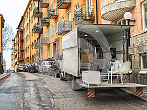 Truck with boxes and other stuff on the street. Moving to the new apartment photo