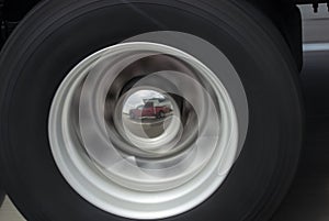 Truck and camper reflected in a hubcap