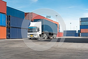 Truck with cargo container on road in shipping yard