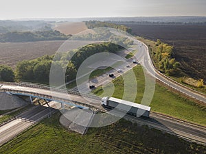 Truck with Cargo Semi Trailer Moving on Road in Direction. Highway intersection junction. Aerial Top View