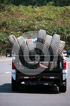 Truck carry big rig semi trucks old used tires on the road