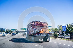 Truck carrying crushed car bodies photo