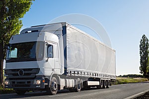 A truck carrying goods during sunny day