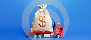 The truck is carrying a huge dollar money bag. Great investment. Attracting large funds to the economy for subsidies, support and photo
