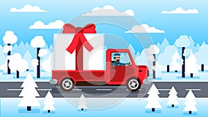 Truck carrying large gift box with red bow