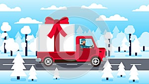 Truck carrying large gift box with red bow