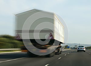 TRUCK CARRYING WIDE LOAD ON MOTORWAY