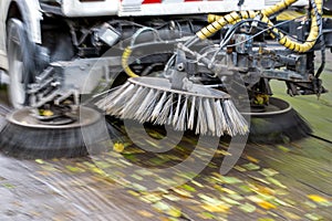 Truck cleaning street at autumn