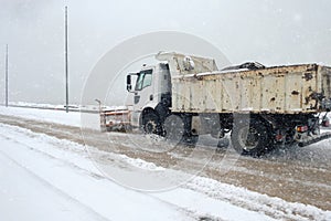 Truck cleaning  winter road covered with snow