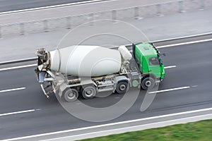 Truck with concrete mixer truck driving on the highway