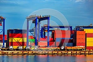 Truck in container depot in import and export area at port near sea.