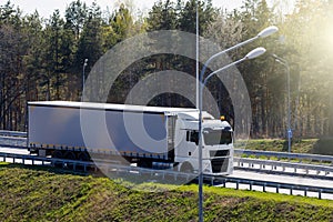 Truck with container on highway, cargo transportation concept.