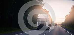 Truck with container on highway with sun light. Concept cargo transportation banner. Blur move effect