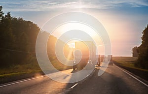 Truck with container on highway with sun light, concept cargo transportation. Blur move effect