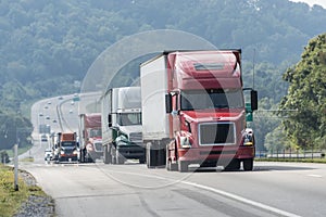 Truck Convoy Traveling On Highway