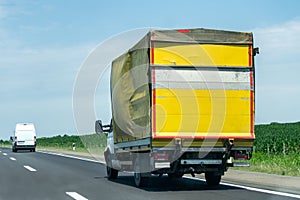 Truck on country highway under blue sky