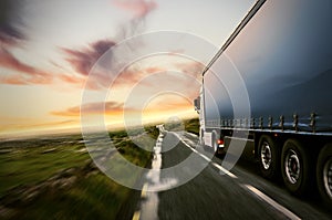 Truck on a country road at sunset