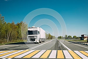 Truck On Country Road. Tractor Unit, Prime Mover, Traction Unit In Motion On Countryside Road In Europe. Business