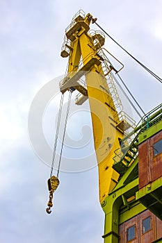 Truck crane boom with hooks and scale weight.