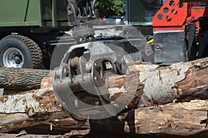 Truck crane hold wood. Wood chipper shredder. A harvester is a type of heavy forestry vehicle employed in cut-to-length logging