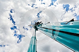 Truck crane with outstretched boom on blue sky background