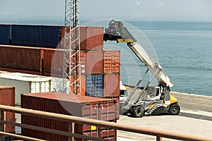 A truck crane unloading shipping containers