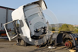 A truck damaged in an accident parked in a parking lot