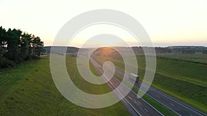Truck Driver Carrying Cargo On Highway At Sunset Background Aerial View