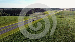 Truck Driver Carrying Cargo On Speed Highway At Sunset Background Aerial View