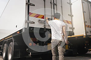 Truck driver checking container door security. Truck inspection safety and maintenance.