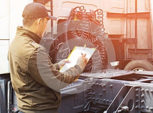 Truck Driver is Checking the Truck`s Safety Maintenance Checklist.