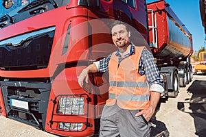 Truck driver in front of his freight forward lorry photo