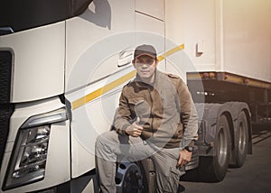 Truck Driver Looking and Giving Thumb-Up with Semi Truck