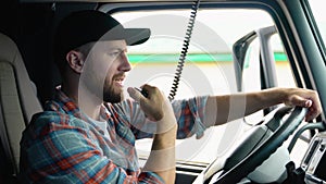 Truck Driver Making Talking Through Radio. Semi Truck