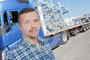 Truck driver posing in front vehicule