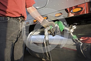 Truck driver pumping gas