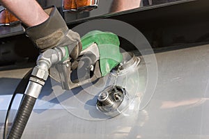 Truck driver pumping gas