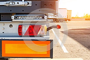 Truck driver semitrailer rear view, warning lights and long length signs on the trailer. Concept of safety and recreation at truck