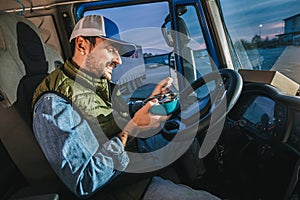 Truck driver taking a break from long drive to eat some food from container