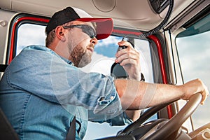 Truck Driver Taking Conversation Using CB Radio photo
