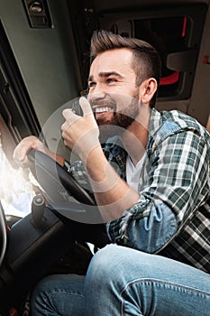 Truck driver talking by CB radio system in his vehicle