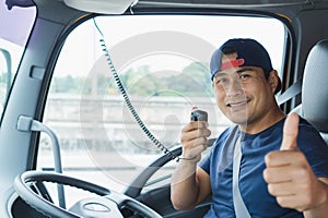 The truck driver is using radio communication