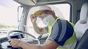 The truck driver wears a medical mask.